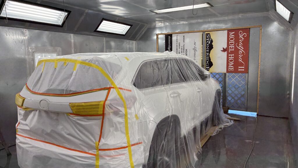 Vehicle masked for paint work inside Pettie's Auto Body paint booth