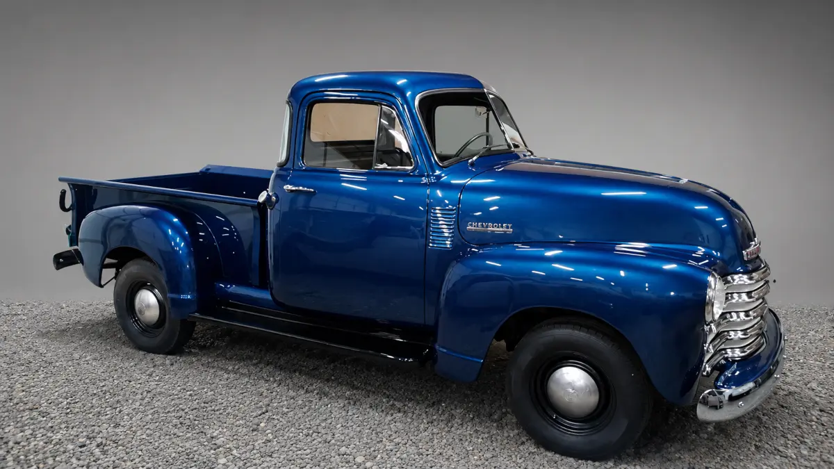 Restored metallic blue vintage Chevrolet pickup after bodywork and paint by Pettie's Auto Body.