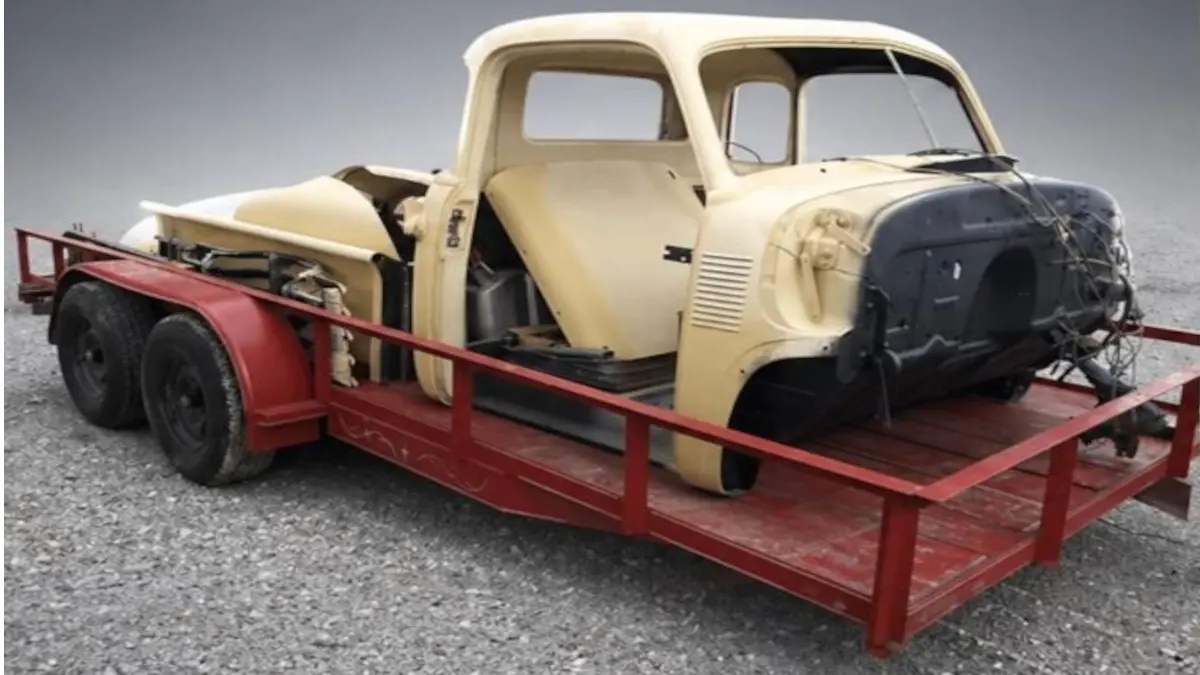 Vintage Chevrolet pickup body shell on a trailer before restoration at Pettie's Auto Body.